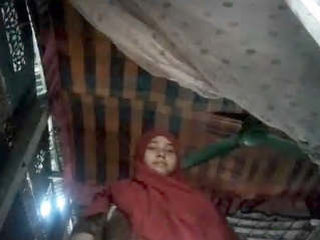 A village woman proudly displays her voluptuous figure