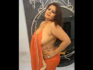 Sapna bhabhi reveals her large breasts as she takes off her orange saree