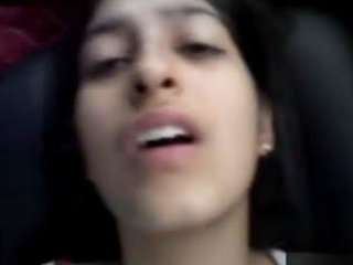 A charming Indian girl engages in solo sex acts inside a car