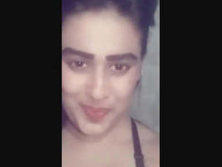 A seductive girl displays her adorable breasts alone