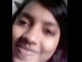 A college girl with large breasts undresses and massages her own breasts