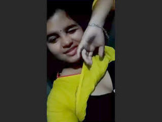 An Indian beauty displays her large breasts and moist vagina in this sensual recording