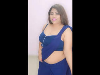 Attractive woman with large breasts performs sensual dance routine