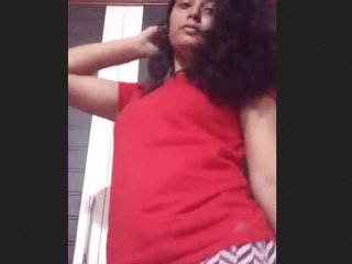 A seductive woman undresses and performs naked choreography for the camera