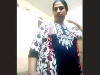 A mature Indian wife undresses for a nude performance