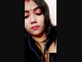 A seductive wife reveals her breasts and intimate area during a video call