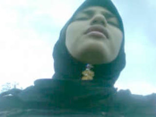 A charming Indian girl with a hijab reveals her breasts and pussy