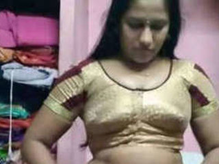 A seductive Indian woman in a black dress gets naughty in the shower