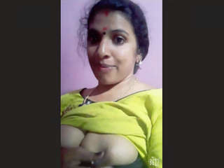 A mallu aunty flaunts her large breasts